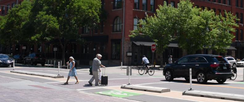 pedestrians in a road crossing with car stopped
